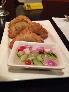 fried puffed pastry with dipping sauce