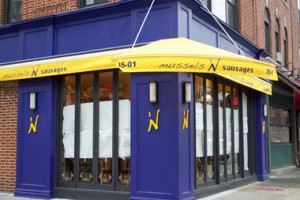 an indigo seafood restaurant with a yellow awning