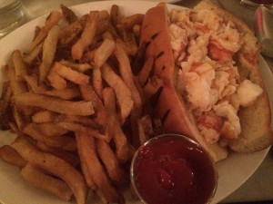 a seafood sandwich with fries and ketchup