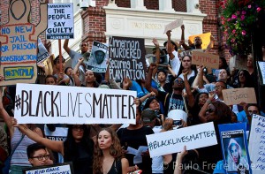 people protesting with "BLACK LIVES MATTER" signs