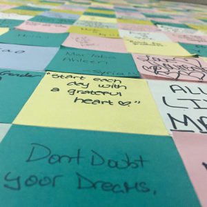 a checkerboard of post-it notes with writing