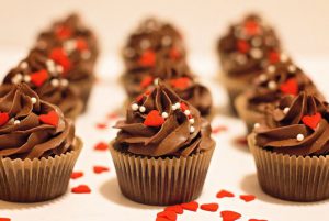 chocolate frosted cupcakes with heart sprinkles