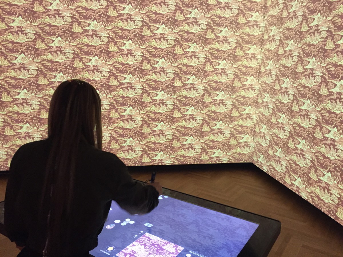 a woman drawing on a digital drawing table