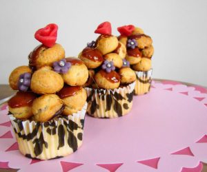 a small tower of mini cream puffs on a cupcake