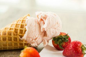 an ice cream cone with strawberries