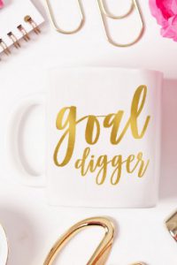 mug that reads goal digger on table with office supplies
