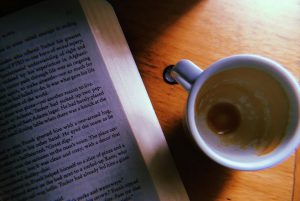 book with empty cup of coffee