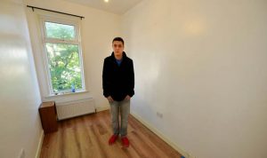 Man standing in small empty room