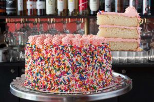 a cake covered in rainbow sprinkles