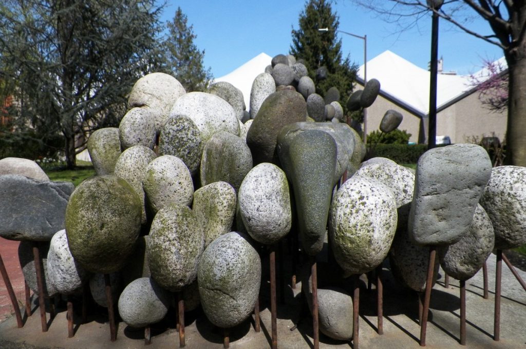 a sculpture of a cluster of stones placed tightly juxtaposed one another