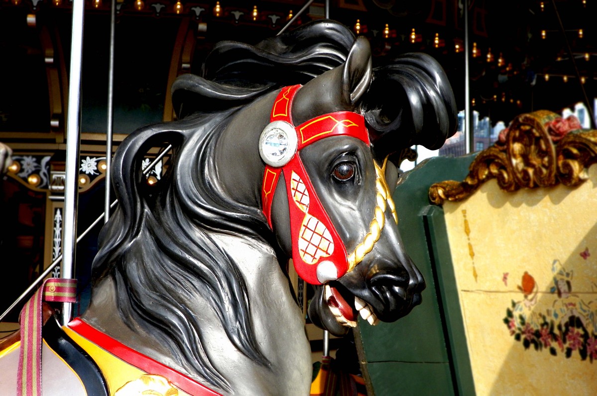 a hand carved face of a black horse