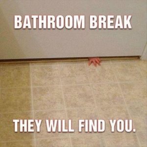 small childs hand sticking under bathroom door
