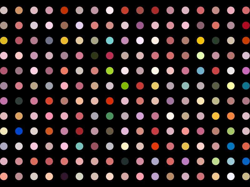 Black background with different color dots arranged in a grid