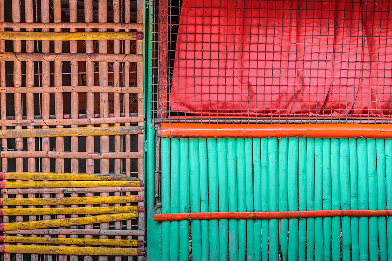 Colorful bamboo slats create the barrier between a room in home and a city sidewalk in Bacolod, Philippines. The different colors match OpenLab colors.