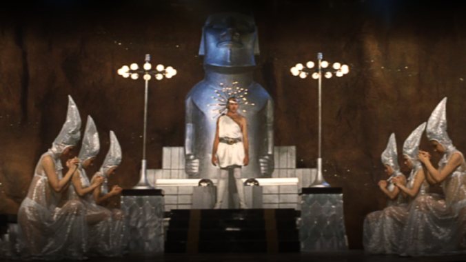 Film still showing a retro-futuristic altar