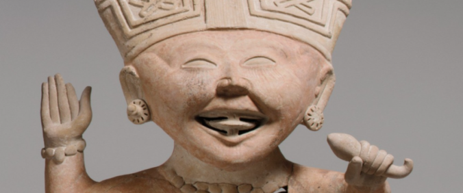 close up on face of a smiling mesoamerican pottery figurine