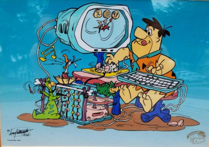 fred flintstone at a computer